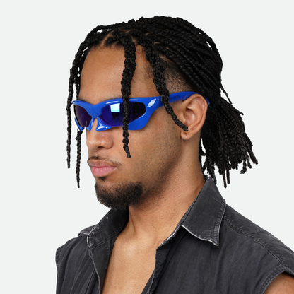 Male model showcasing Ruggeri Carapace sunglasses in striking blue, highlighting the sleek and bold custom-moulded insectoid design with Category 3 UV400 REVO lenses.