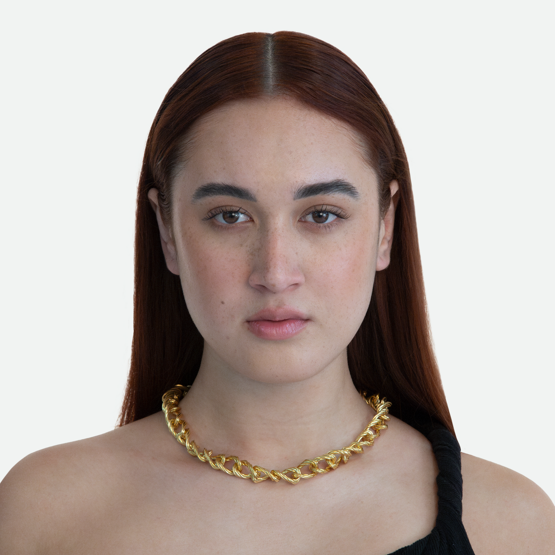 Model wearing the Helix necklace, showcasing the modern design of flowing links in a spiralling chain, on a white background.