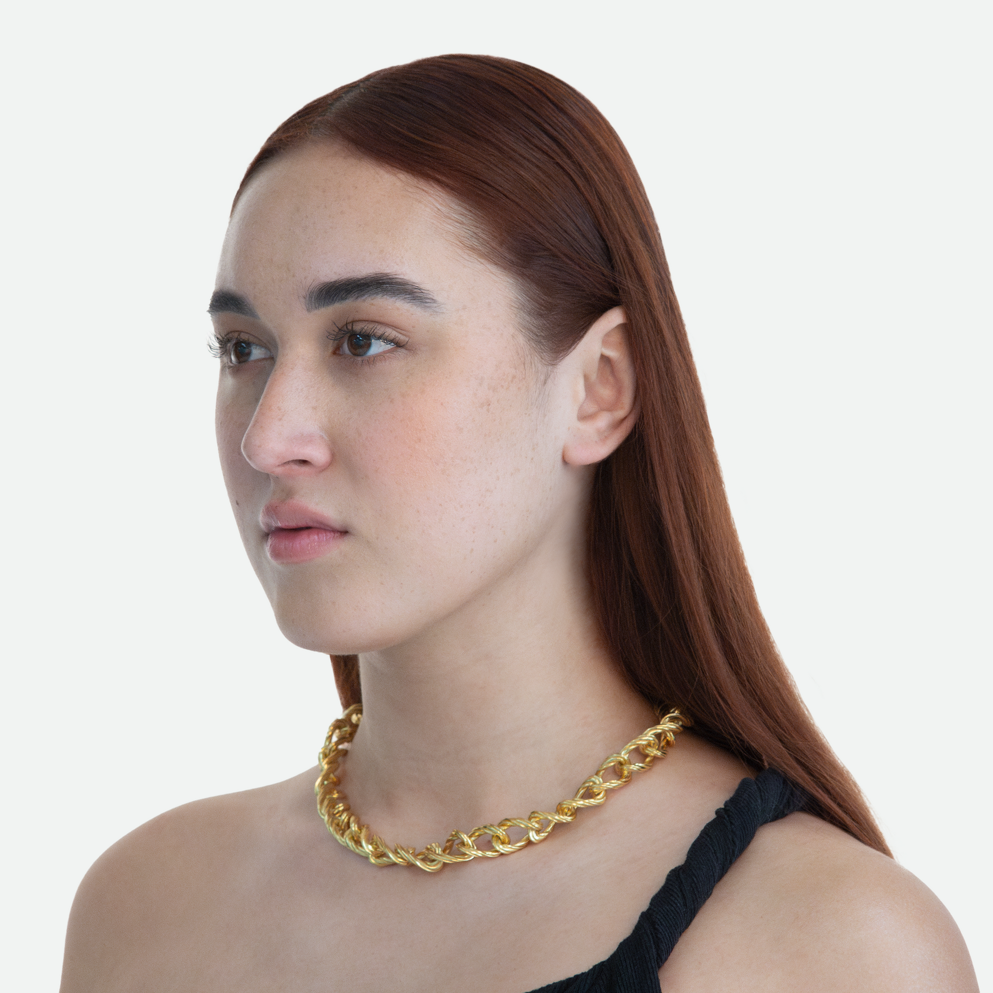 Model at a 45-degree angle view wearing the Helix necklace, highlighting the signature twisting design and seamless flow of gold links, on a white background.