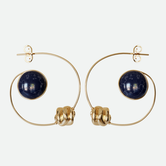 Orbit earrings with Sodalite stone and bead suspended within a gold plated arc, evoking a planet and its moon, designed by Ruggeri.