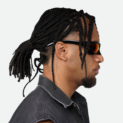 Side view of male model wearing Ruggeri Carapace sunglasses with black frames and vivid red lenses, showcasing the sleek custom-moulded insectoid design with Category 3 UV400 REVO lenses.