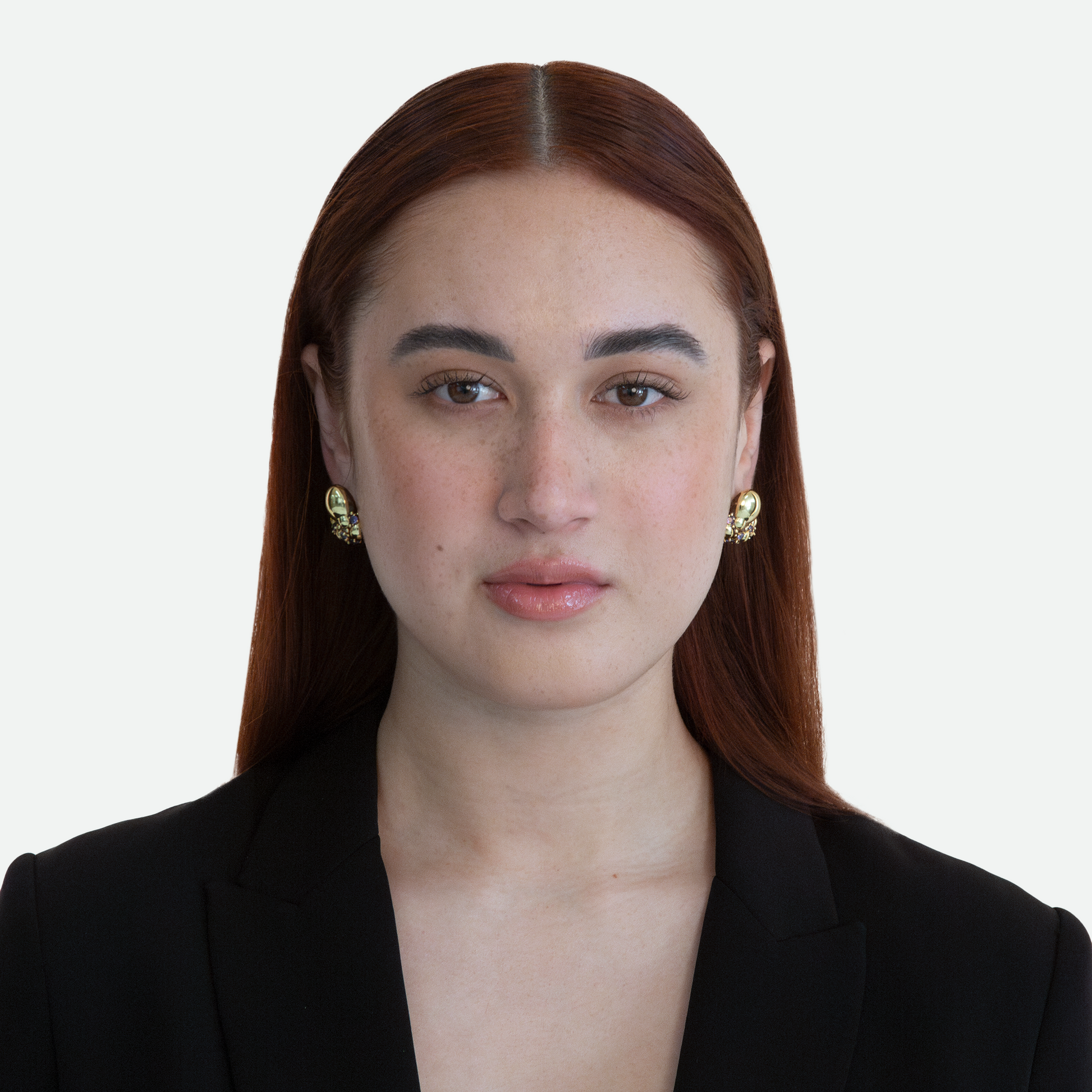 Model showcasing the Ribolle earring, featuring a gold plated bubbling form studded with sapphire cubic zirconia crystals and hand painted enamel, on a white background.