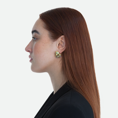 Side profile of model wearing the Ribolle earring, emphasizing the abstract design, cubic zirconia crystals, and hand painted enamel finish, on a white background.