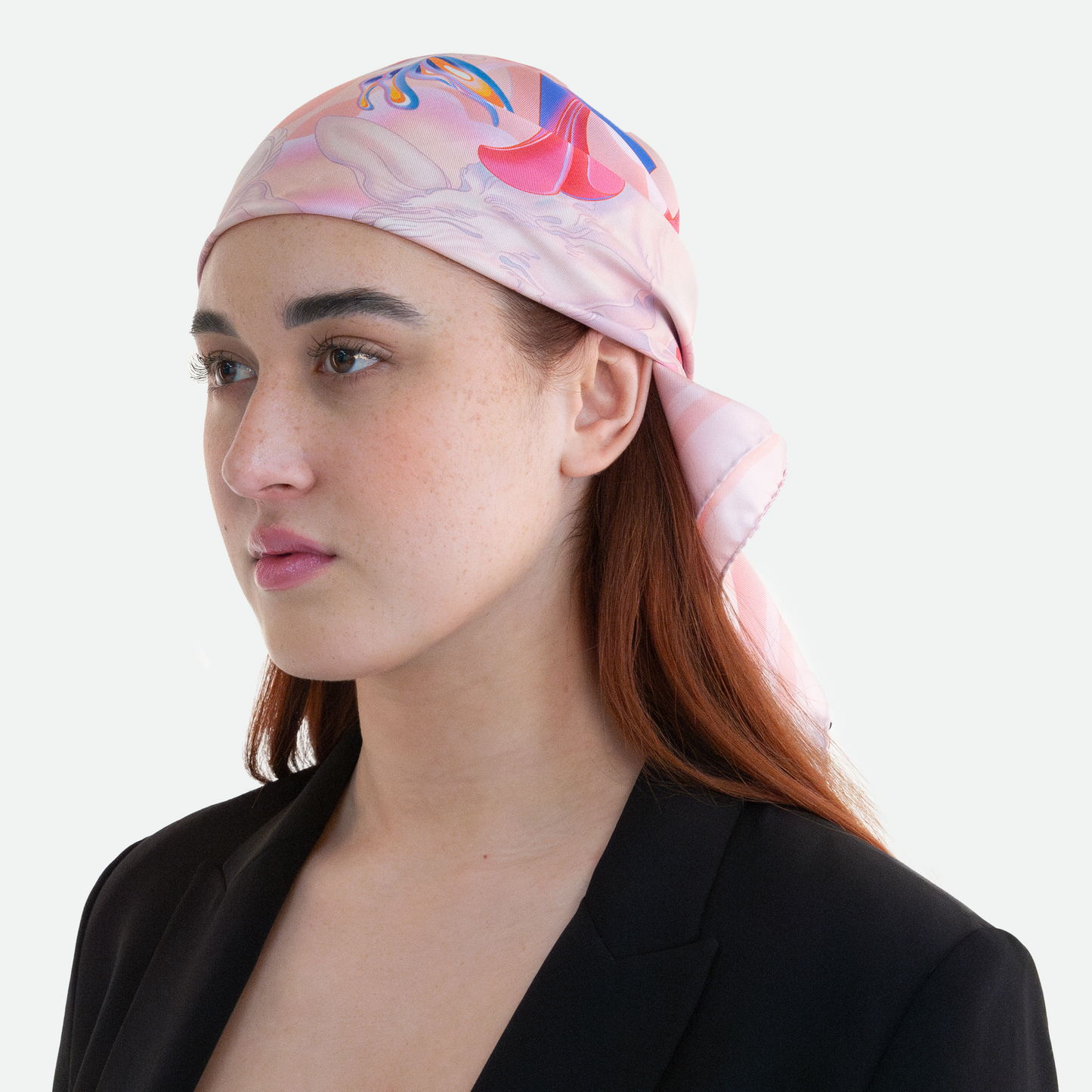 Model at a 45-degree angle view showcasing the Ruggeri lamb print silk scarf worn as a headscarf, emphasizing its detailed line-work and lively color palette.