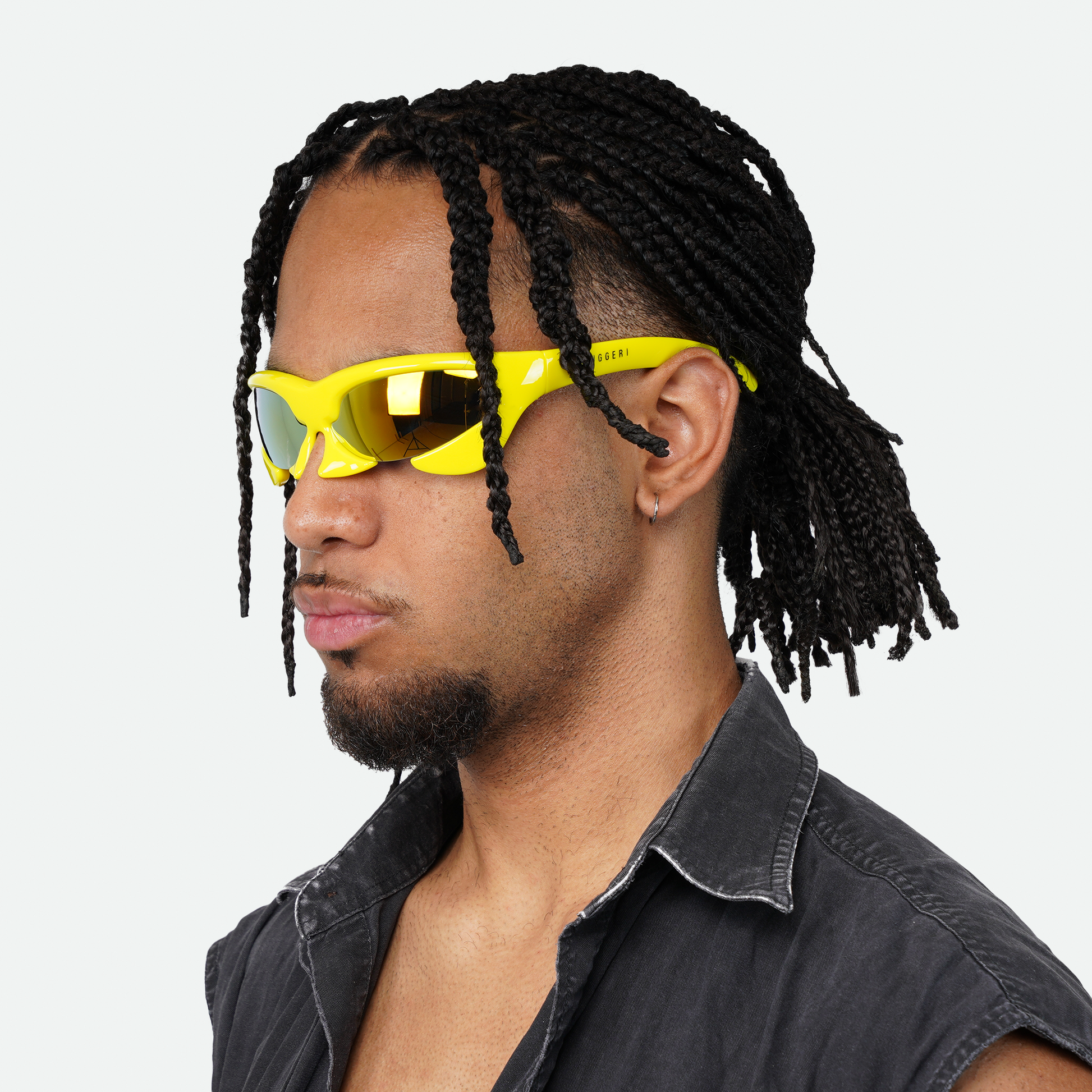 Male model showcasing Ruggeri Carapace sunglasses with eye-catching yellow frames and dynamic blue/orange lenses, highlighting the sleek and bold custom-moulded insectoid design with Category 3 UV400 REVO lenses.