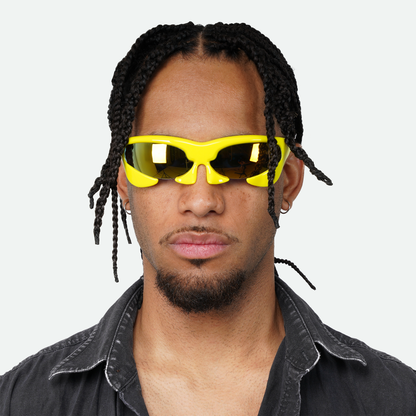 Front view of male model wearing Ruggeri Carapace sunglasses with vivid yellow frames and striking blue/orange lenses, emphasizing the unique custom-moulded insectoid appearance with Category 3 UV400 REVO lenses.